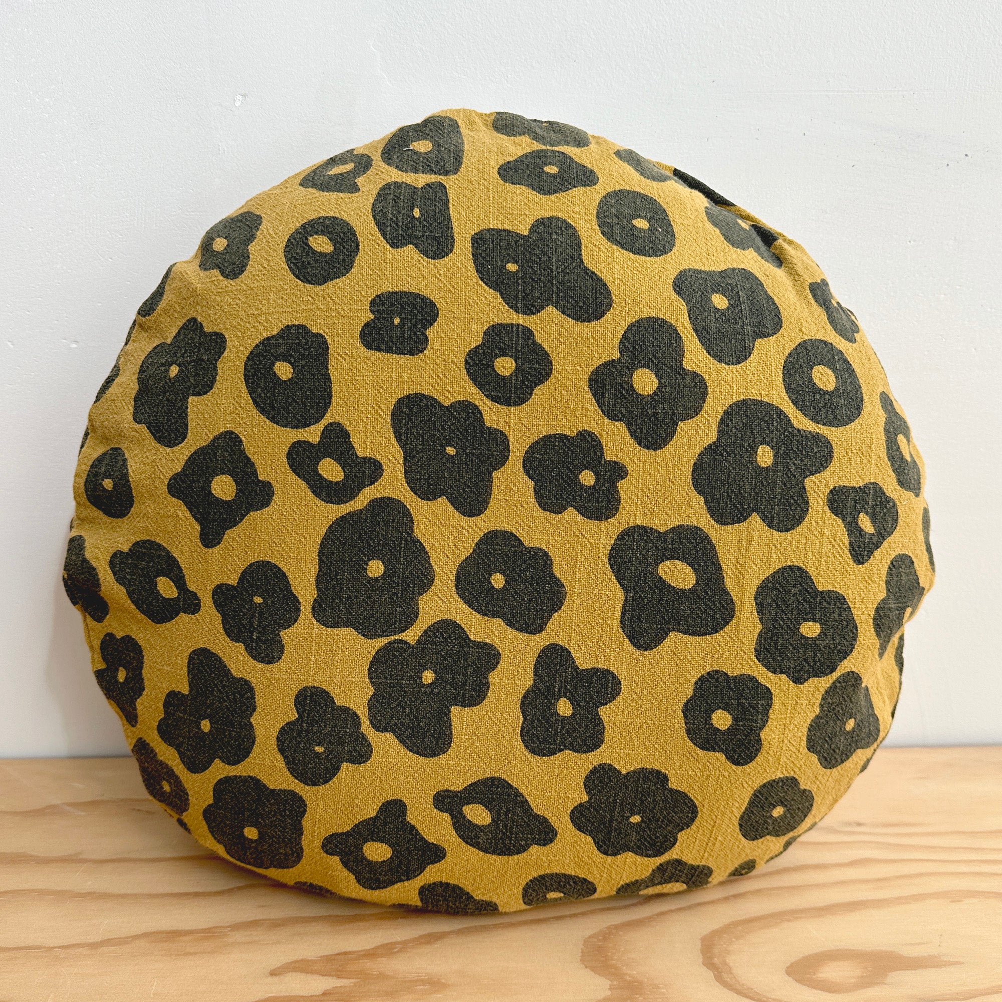 The Round Throw Pillow - Celeste in Faded Black and Raw Sienna