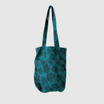 Teal tote bag with black pattern on a white background