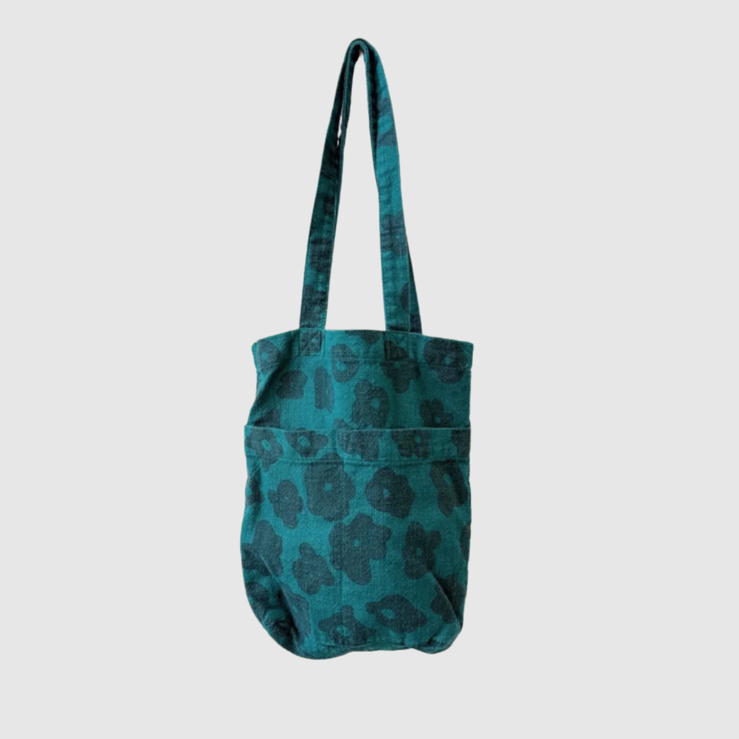 Teal tote bag with black pattern on a white background